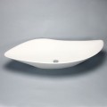 Large, asymmetrical composite landing basin